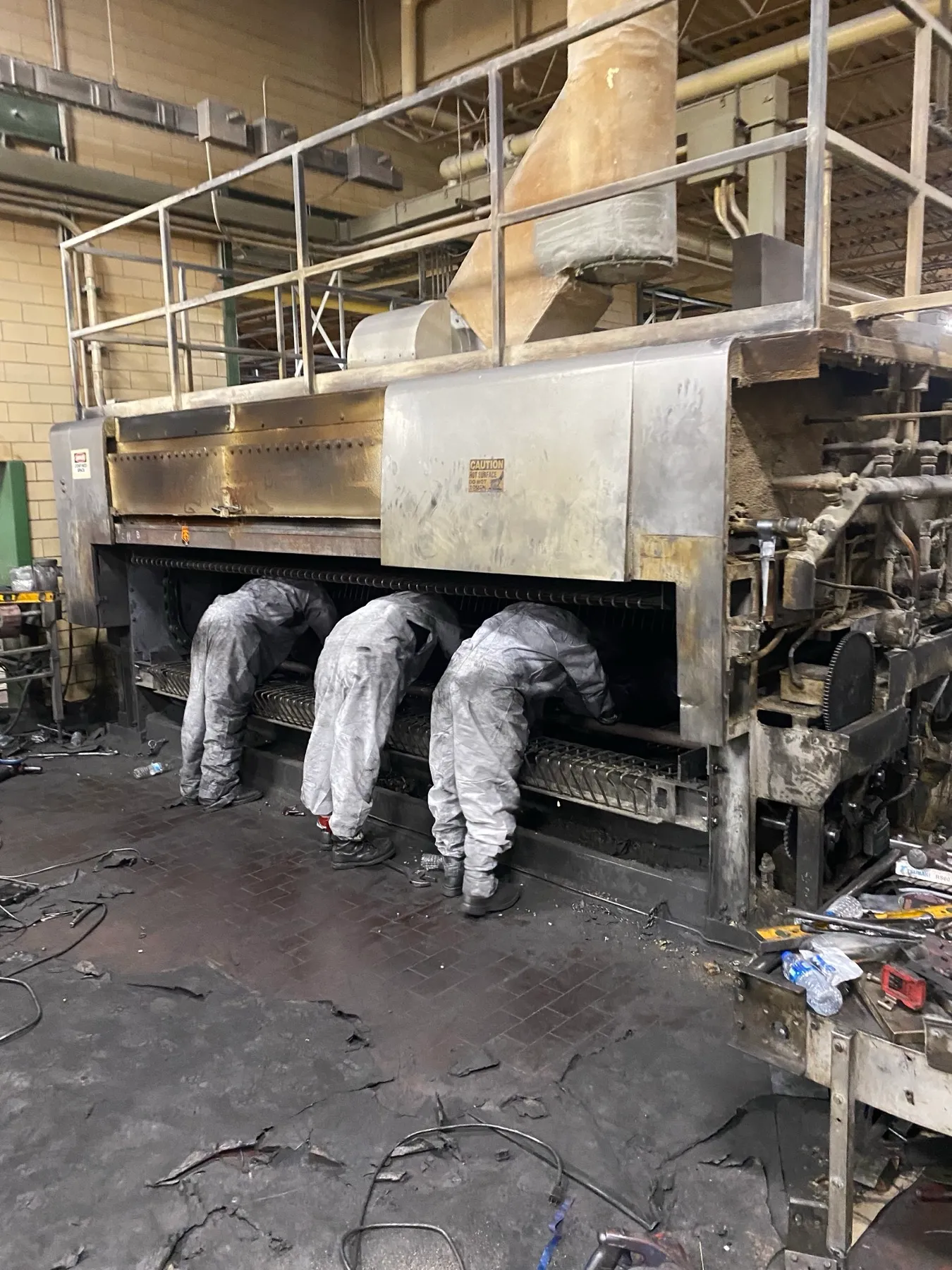 Field service beneath an industrial oven
