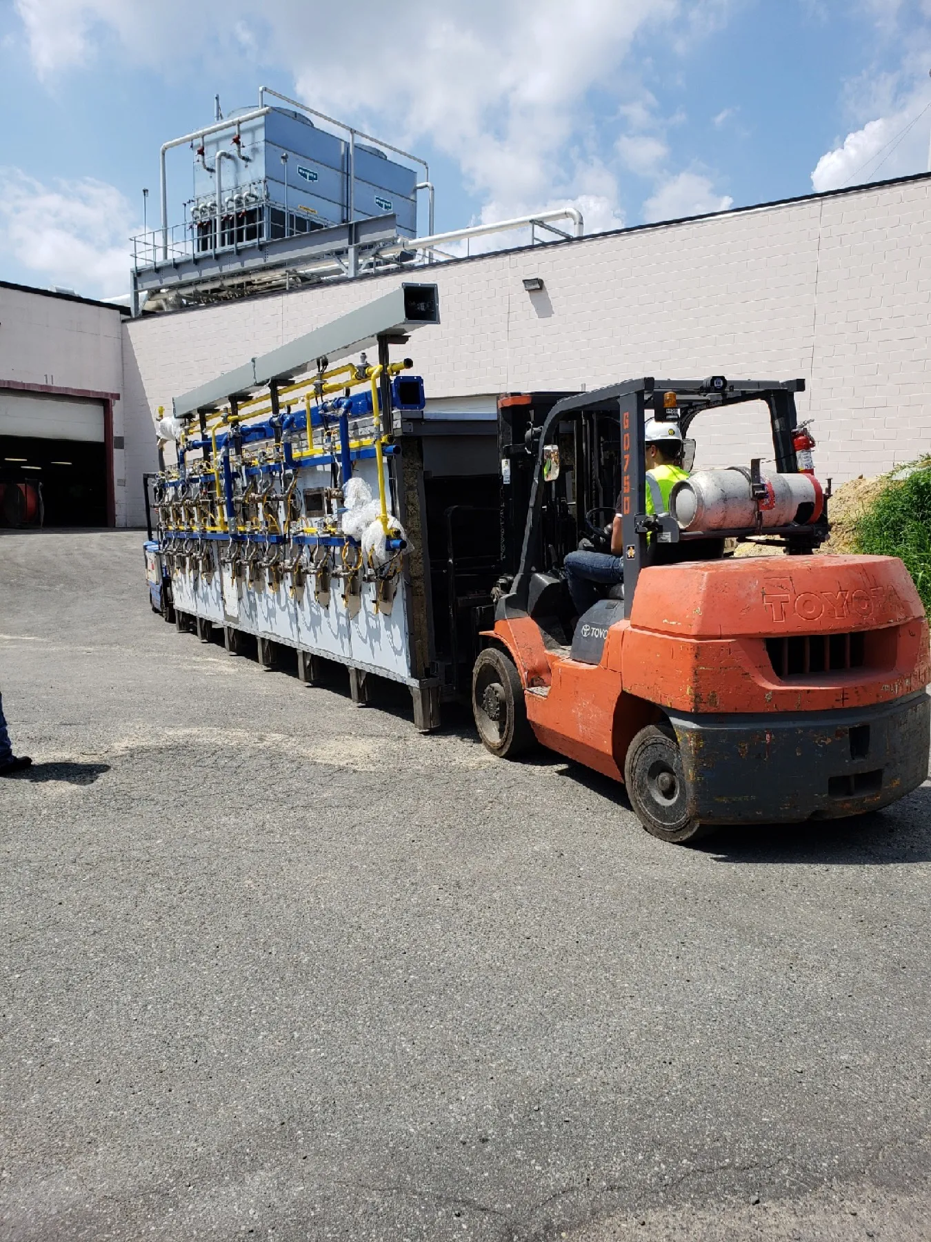 Forklift positioning an oven module